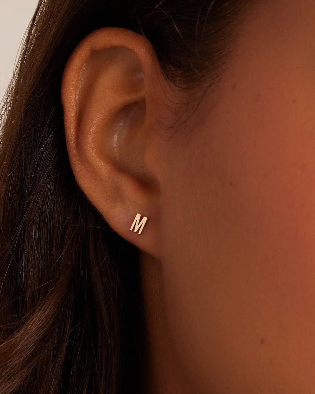 Woman wearing alphabet earring stud || option::14k Solid Gold, M, Single