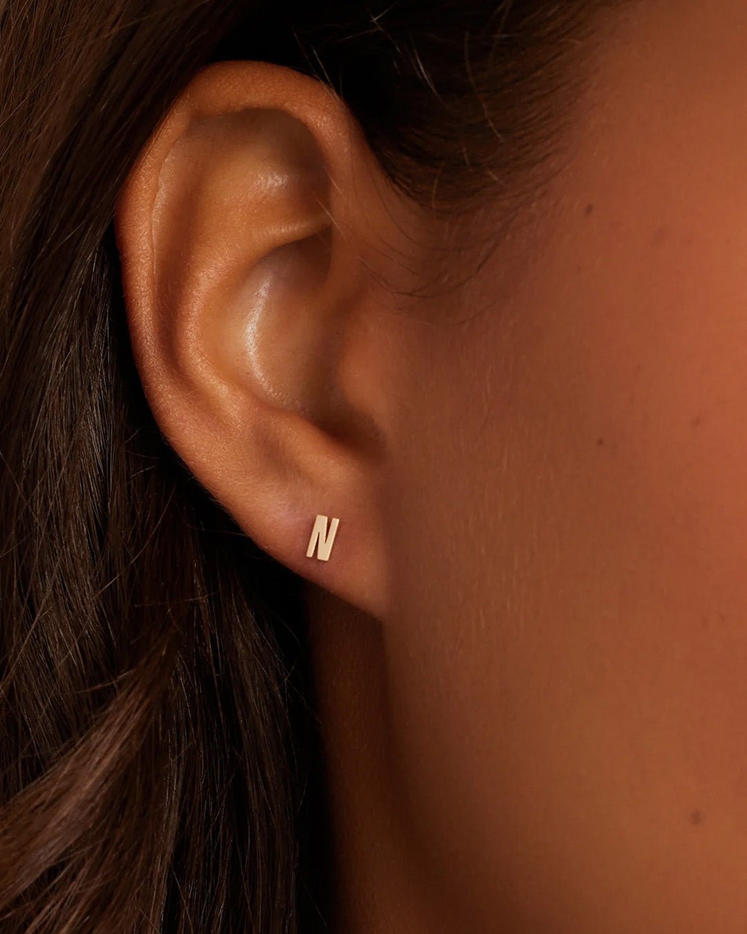 Woman wearing alphabet earring stud || option::14k Solid Gold, N, Single