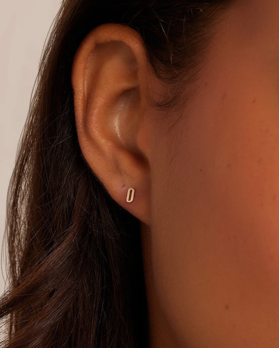 Woman wearing alphabet earring stud || option::14k Solid Gold, O, Single