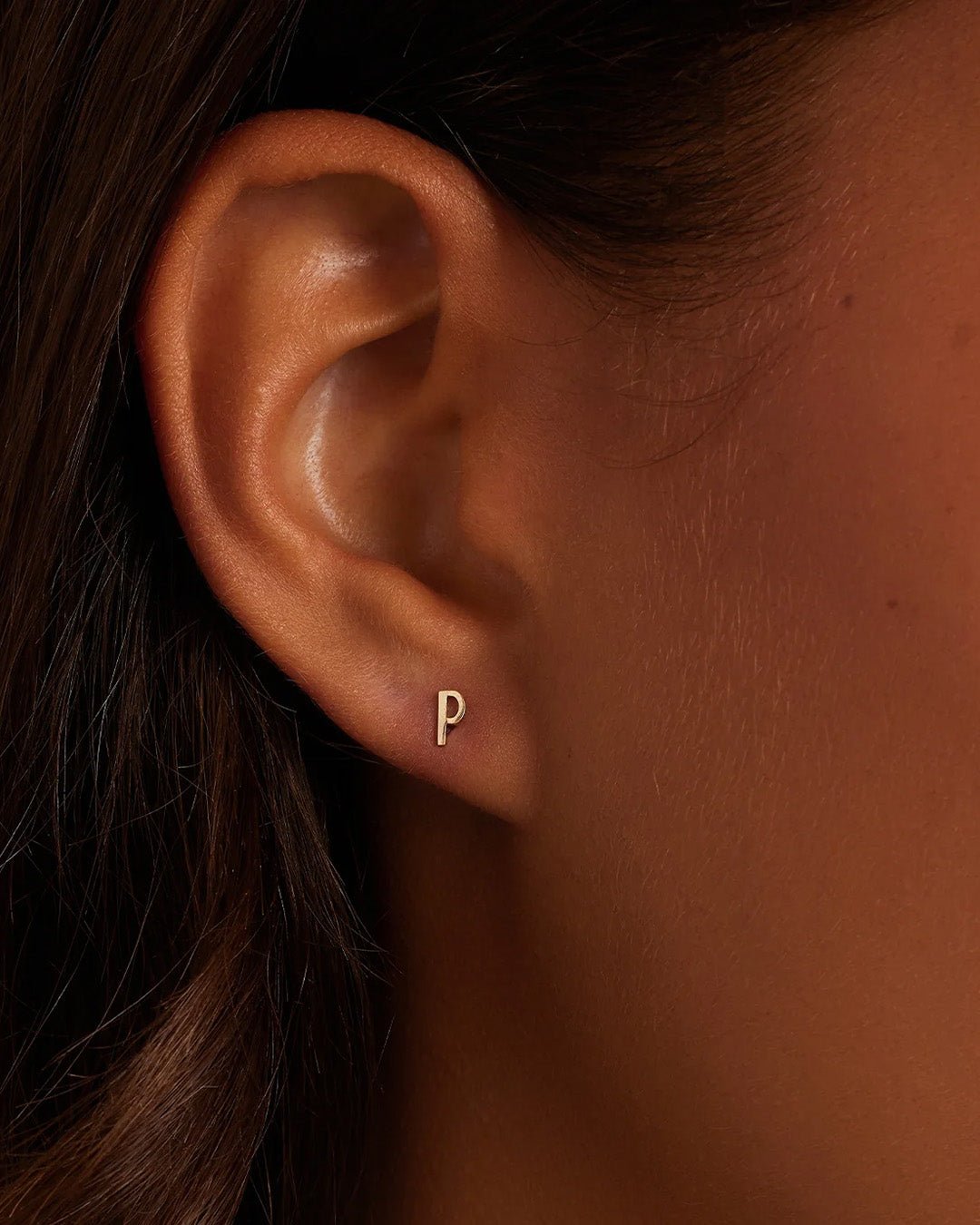 Woman wearing alphabet earring stud || option::14k Solid Gold, P, Single