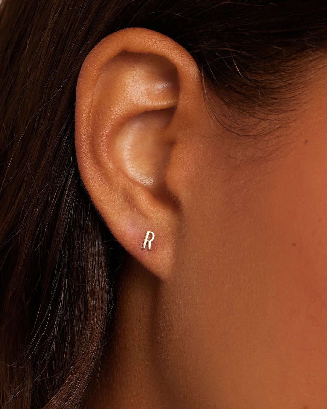 Woman wearing alphabet earring stud || option::14k Solid Gold, R, Single