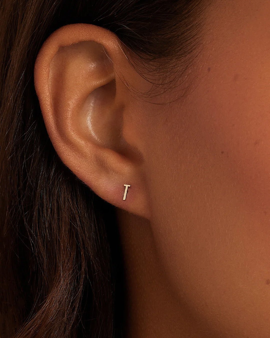 Woman wearing alphabet earring stud || option::14k Solid Gold, T, Single