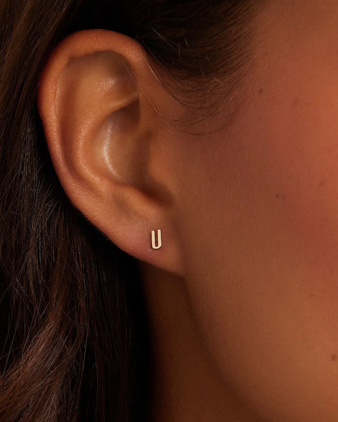 Woman wearing alphabet earring stud || option::14k Solid Gold, U, Single