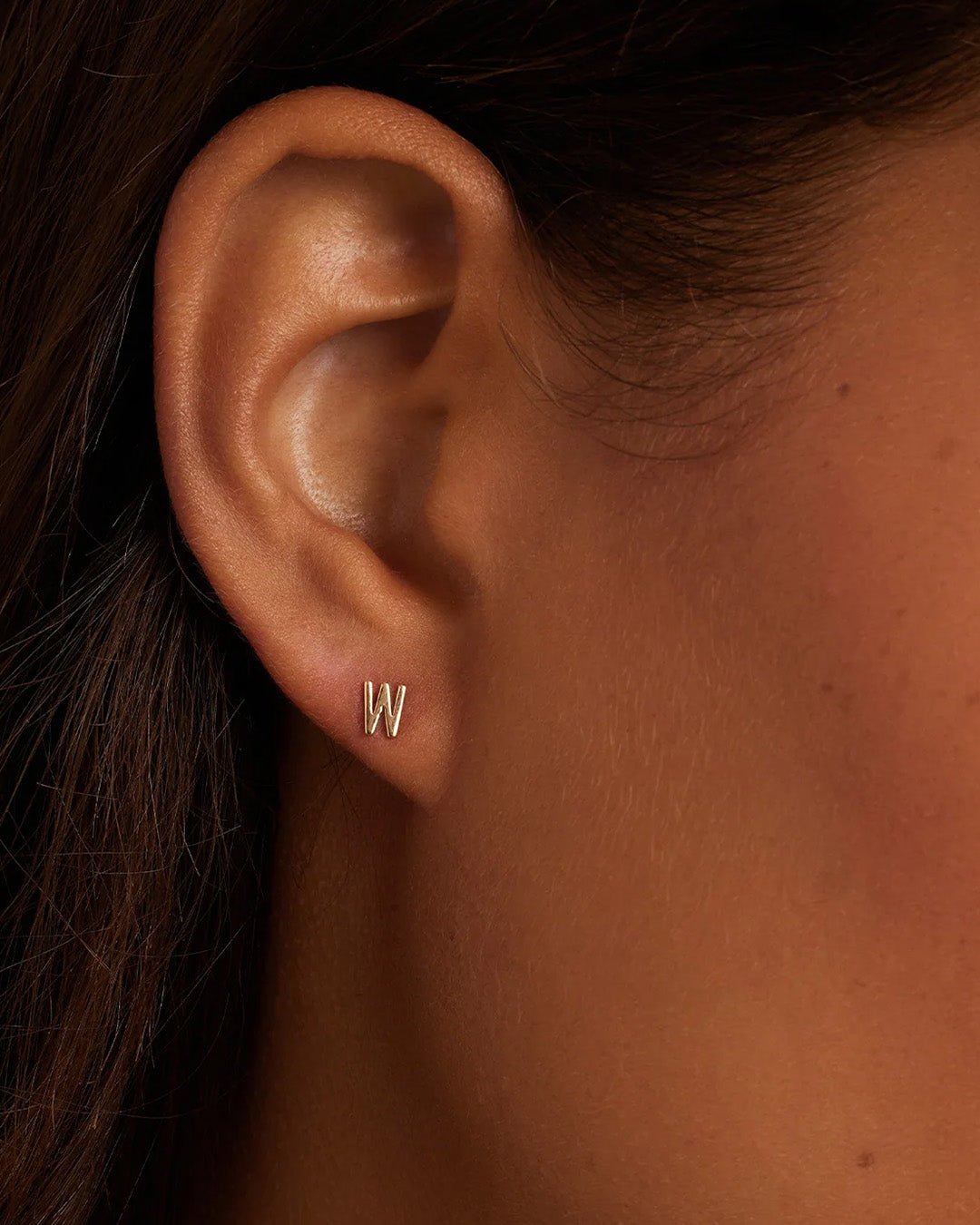 Woman wearing alphabet earring stud || option::14k Solid Gold, W, Single
