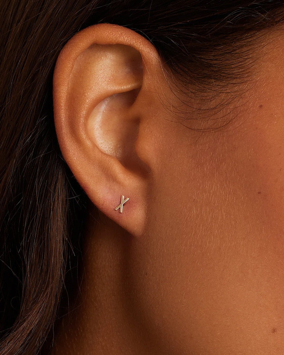 Woman wearing alphabet earring stud || option::14k Solid Gold, X, Single